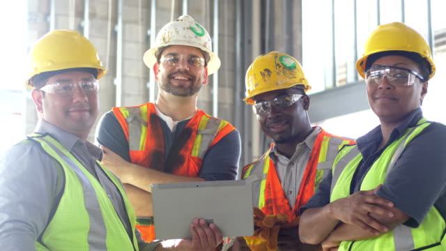construction workers looking at a tablet