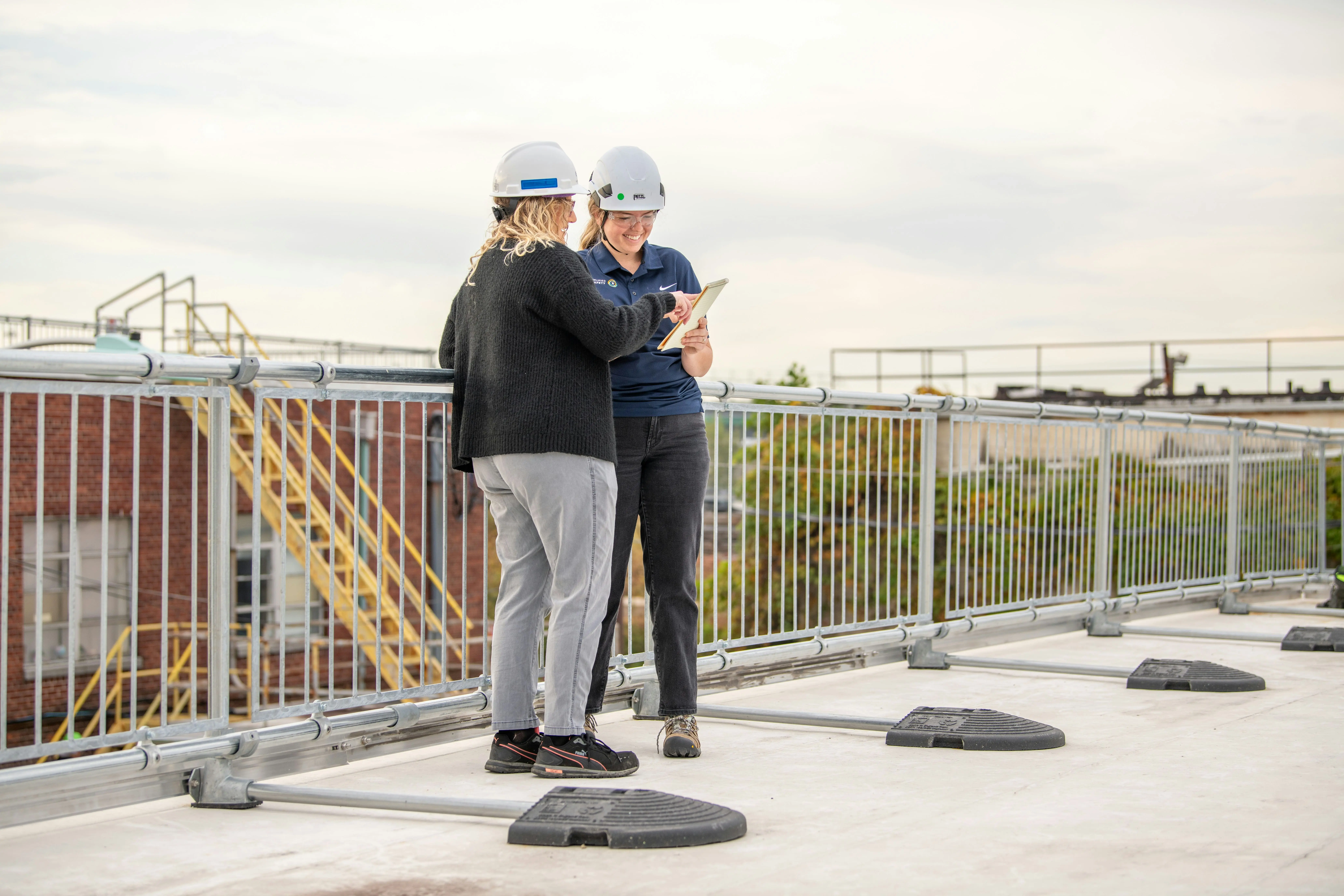 two women doing a rooftop inspection